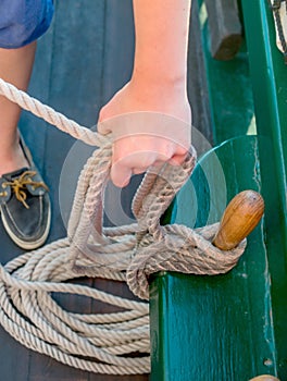 A sailor ties ropes securely on a ship