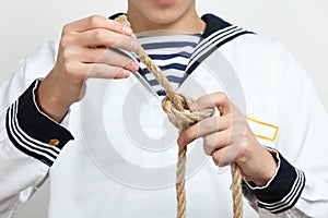 Sailor tying a sea knot