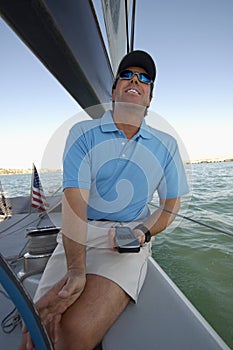 Sailor using navigation equipment on boat