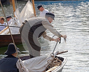 Sailor in vintage clothes fixing the anchor