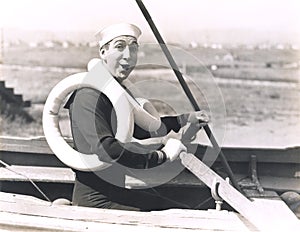 Sailor wearing two life preservers photo