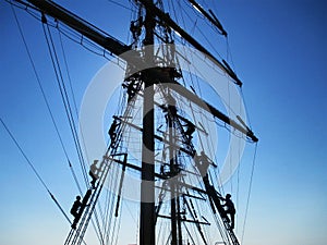 Sailors climb the mast