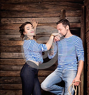 Sailors couple love story. Man kissing woman hand. Wooden background