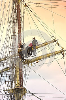 Sailors on sailboat rigging photo