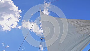 Sails of a sailing boat in caribbean sea against sunny sky