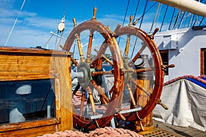 Sailship deck with helm, rigging and cables.