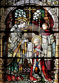 Saint Aloysius is given his first communion by Saint Charles Borromeo