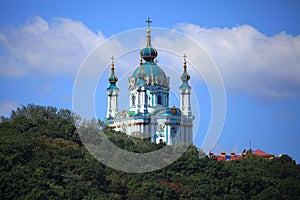 Saint Andrewâ€™s church on Kievâ€™s green hills background