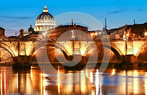 The Saint Angel bridge and St. Peter`s Basilica , Rome, Italy .