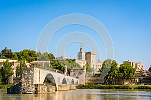 The Saint-Benezet bridge on the Rhone river and the Papal palace in Avignon, France