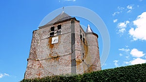 Saint Corneille et Saint Cyprien fortified catholic church with defense tower in the village of Hary