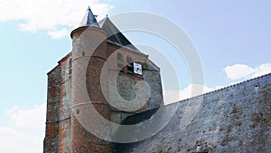Saint Corneille et Saint Cyprien fortified catholic church with defense tower in the village of Hary in the Aisne