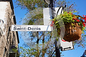 Saint Denis street sign attached to lamp post in Montreal Quebec photo