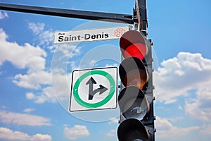 Saint Denis street sign attached to a traffic light in Montreal