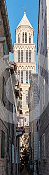 Saint Dominus cathedral belltower seen from a different angle, from inbetween the tiny streets between buildings. Vertical shot