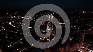 The Saint Eusebius Church or Grote Kerk in Arnhem city in the Netherlands by night, Aerial drone. City center, skyline