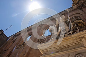 The saint on the facade of the church of St. Publius` points to the sun with his finger