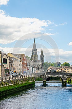 Saint Fin Barre`s Cathedral and  south gate bridge on river Lee in Cork