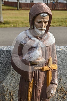 Saint Francis of Assisi Statue Holding a Dove and Cross photo