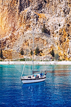 Saint George bay on Symi island, popular stop over for tourists to have a swim in the turquoise waters, Symi island, Greece. Boat