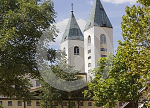 Saint James belfries in Medjugorje, surrounded by nature in summer season