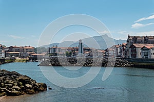 Saint Jean de Luz: Coastal charms with old lighthouse and basque mountains in the background photo