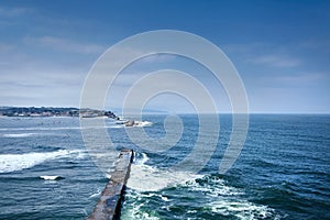 Saint Jean de Luz, France. Basque country. City views Ciboure and Castle and port of Socoa. Ocean waves breaking about the dam