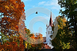 Saint John church in Cesis, Latvia captured surrounded by autumn foliage, fall colors