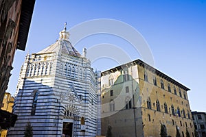 Saint John`s baptistery in Pistoia city built in the year 1303 with an octagonal base - On the left the Episcopal Palace Tuscany