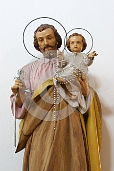 Saint Joseph holding child Jesus