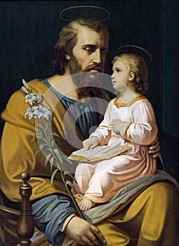 Saint Joseph holding child Jesus photo