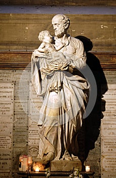 Saint Joseph holding child Jesus, statue in the Saint Sulpice Church, Paris