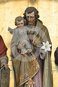 Saint Joseph holds the baby Jesus, a statue on the high altar in the church of Saint Joseph in Slatina, Croatia