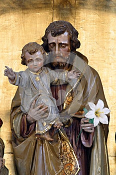 Saint Joseph holds the baby Jesus, a statue on the high altar in the church of Saint Joseph in Slatina, Croatia