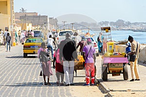 Unidentified Senegalese peopel sell fruits beside the road in S