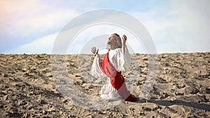 Saint man praying to God in desert, asking salvation, faith in better life