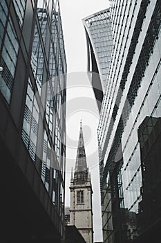 Saint Margaret Pattens Church of England between modern glass towers
