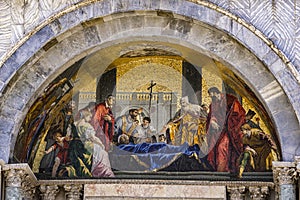 Saint Mark`s body venerated by the doge mosaic at facade of Basilica di San Marco in Venice, Italy