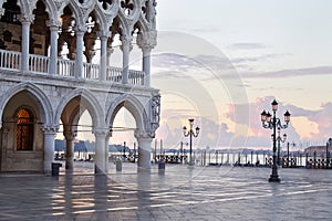 Saint Mark square in Venice with pink sky and lagoon in Italy