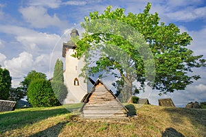 Saint Martin's Church in Martincek with wooden marquises around during summer sunset