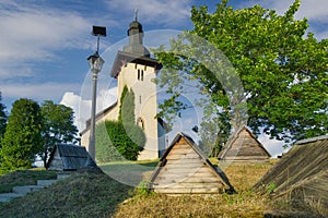 Saint Martinâs Church in Martincek with wooden marquises around during summer sunset