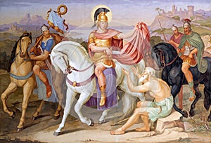 Saint Martin of Tours cuting a piece of his cloak for a beggar photo