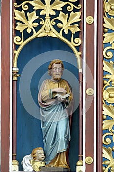 Saint Matthew the Evangelist, statue on the main altar in the church of Our Lady of Miracles in Ostarije, Croatia photo