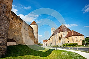 Saint-Maurice church and walls of Blandy castle in France photo