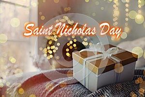Saint Nicholas Day. Beautiful gift box on bed in room