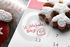 Saint Nicholas Day. Calendar with marked date December 06 and gingerbread cookies, closeup