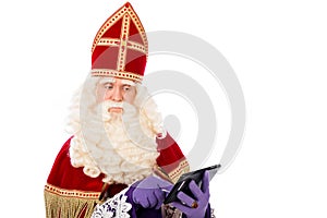 Saint Nicholas looking on tablet or smart phone