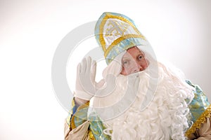 saint nicholas waving bye bye Sinterklaas portrait gold with blue headdress lush beard and white mustache white gloves