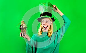 Saint Patrick day celebration. Blonde woman in green sweater and leprechaun hat. Patricks day. Happy girl in green