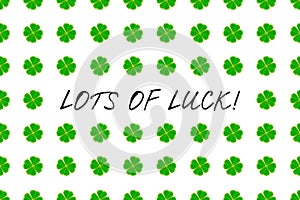 Saint Patrick`s Day greeting card with green mosaic clover leaves and text on white background. Inscription - LOTS OF LUCK!